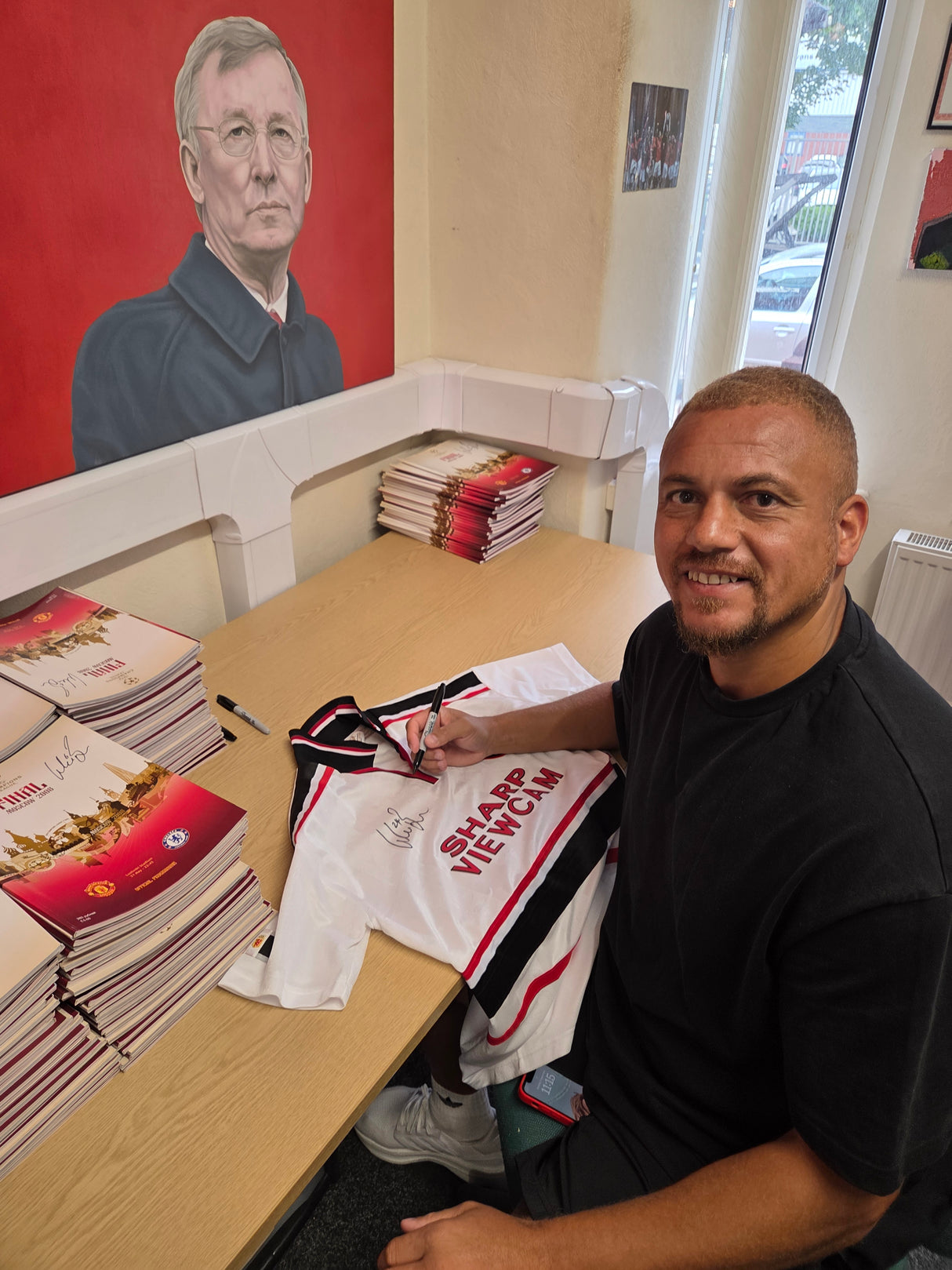 Wes signing in the MUST Office