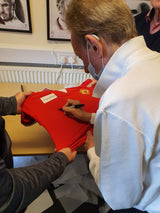 Denis Law signing 1973 Manchester United shirts - in this example doing dedications